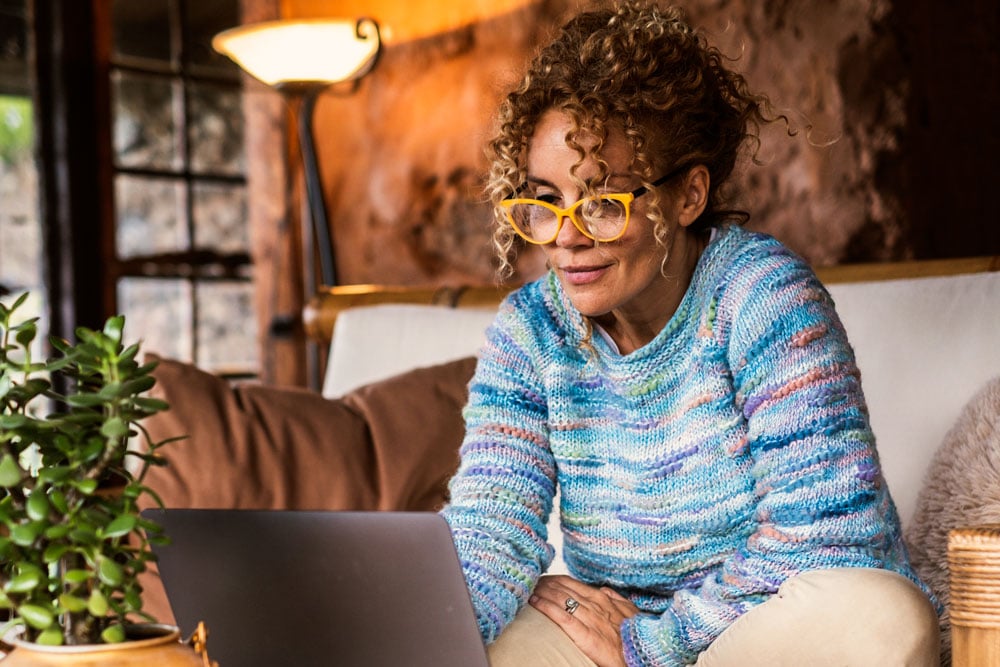 Woman reviewing candidacy for cataract surgery in Lubbock on a laptop.
