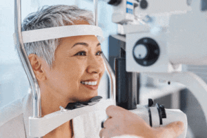 Senior woman taking a slit lamp test at West Texas Eye Associates.