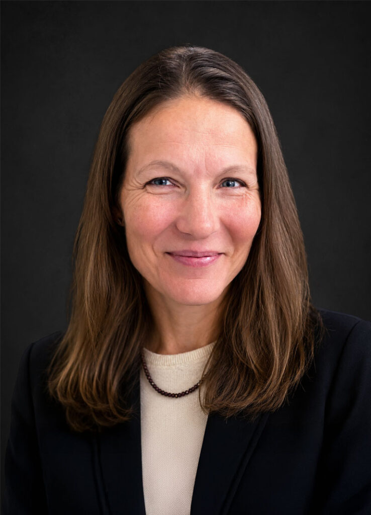 Professional headshot of Dr. Lisa McIntire, MD against a black background.