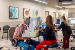 An eye care technician assists a patient with diagnostic eye imaging at West Texas Eye Associates, offering a look at what to expect during your eye care appointment.